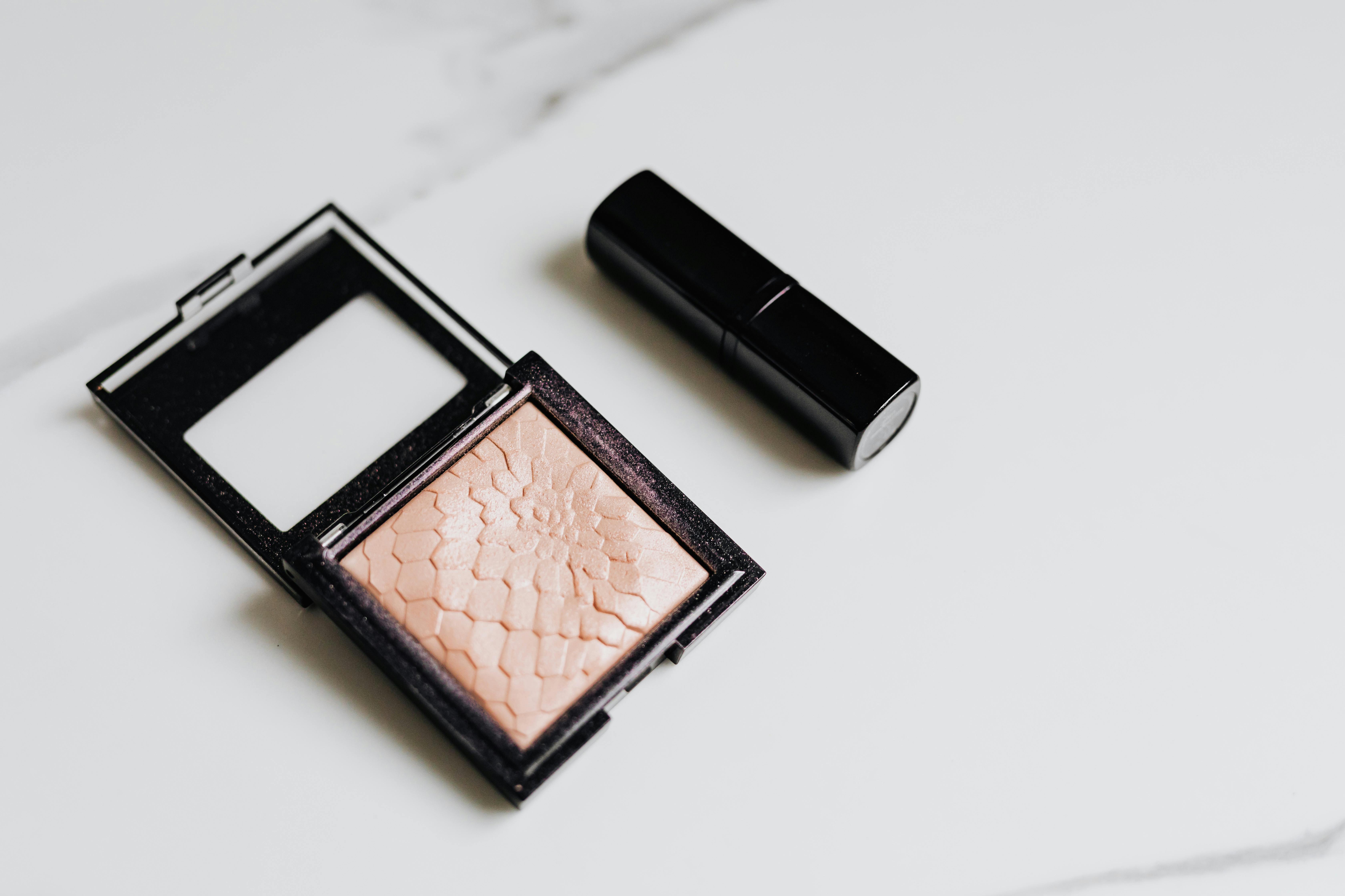 Open compact case with shimmery highlighter powder