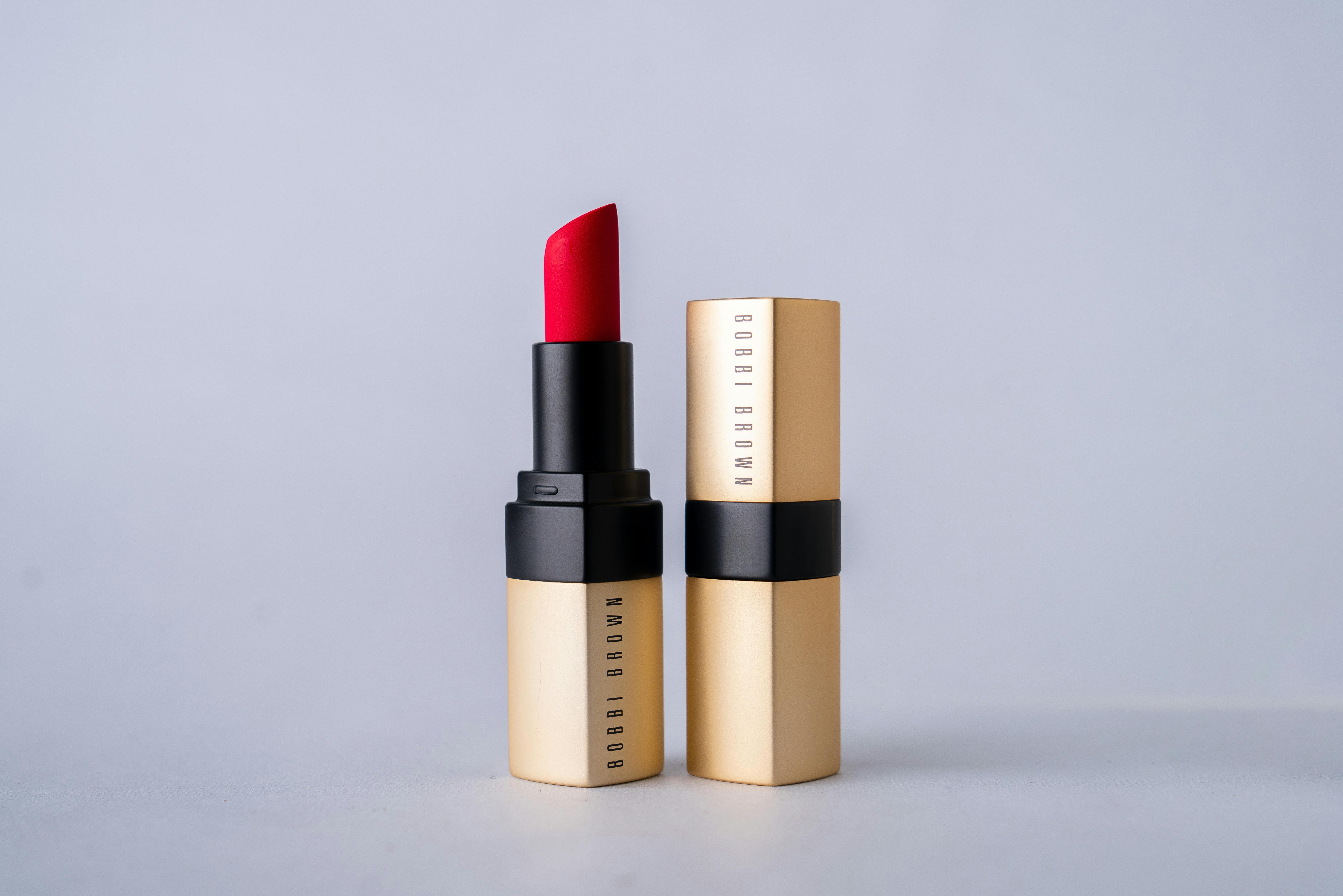 Two lipstick tubes with red lipstick